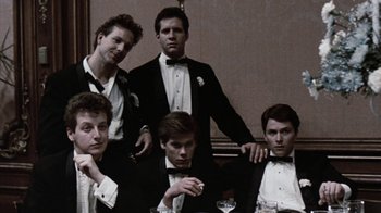 Movie still from “Diner” (1982), directed by Barry Levinson – A group of men in tuxedos posing for a picture; Medium shot, Low angle