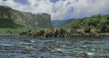 Movie still from “Dinosaur” (2000), directed by Eric Leighton – A herd of elephants walking across a body of water; Extreme Wide shot, High angle