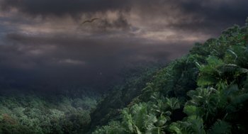 Movie still from “Dinosaur” (2000), directed by Eric Leighton – A bird flying in the sky over a lush green forest; Extreme Wide shot, High angle