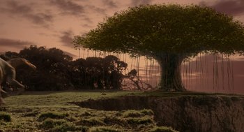 Movie still from “Dinosaur” (2000), directed by Eric Leighton – An image of a tree in the middle of a field; Extreme Wide shot, High angle