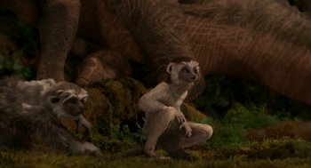 Movie still from “Dinosaur” (2000), directed by Eric Leighton – A group of animals that are sitting in the grass; Wide shot, High angle