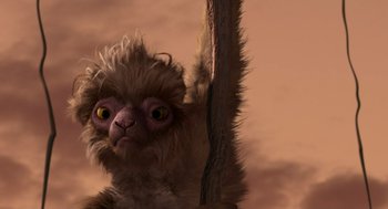 Movie still from “Dinosaur” (2000), directed by Eric Leighton – A monkey hanging from a tree branch in the sky; Close Up shot, Low angle