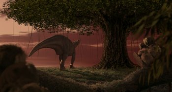 Movie still from “Dinosaur” (2000), directed by Eric Leighton – An image of a dinosaur under a tree in the wild; Extreme Wide shot, Low angle