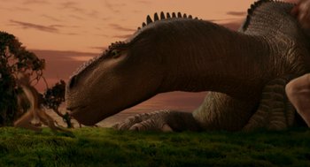 Movie still from “Dinosaur” (2000), directed by Eric Leighton – An image of an animal that is laying in the grass; Wide shot, Low angle