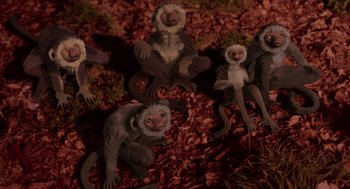 Movie still from “Dinosaur” (2000), directed by Eric Leighton – A group of monkeys that are sitting in the dirt; Wide shot, High angle