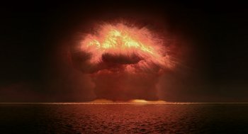 Movie still from “Dinosaur” (2000), directed by Eric Leighton – An explosion is seen from the ocean at night; Extreme Wide shot, High angle