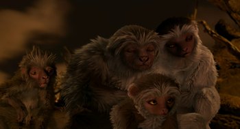 Movie still from “Dinosaur” (2000), directed by Eric Leighton – A group of three stuffed monkeys sitting next to each other; Close Up shot, Low angle