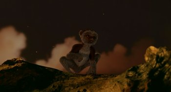 Movie still from “Dinosaur” (2000), directed by Eric Leighton – A monkey standing on top of a hill at night; Wide shot, Low angle