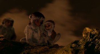 Movie still from “Dinosaur” (2000), directed by Eric Leighton – A couple of monkeys sitting on top of a rock; Wide shot, High angle