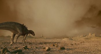 Movie still from “Dinosaur” (2000), directed by Eric Leighton – An animal walking across a barren field in the desert; Extreme Wide shot, Low angle