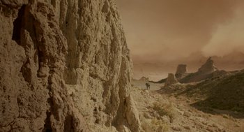 Movie still from “Dinosaur” (2000), directed by Eric Leighton – A man riding a horse on top of a mountain; Extreme Wide shot, Low angle