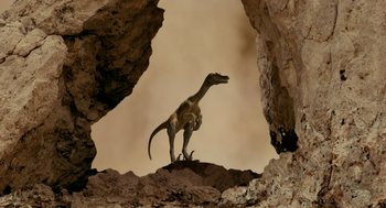 Movie still from “Dinosaur” (2000), directed by Eric Leighton – A dinosaur that is standing on the rocks; Wide shot, Low angle