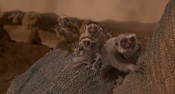 Movie still from “Dinosaur” (2000), directed by Eric Leighton – A group of monkeys sitting on top of a hill; Wide shot, High angle