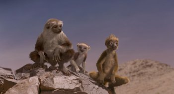 Movie still from “Dinosaur” (2000), directed by Eric Leighton – A group of monkeys sitting on top of a rock; Wide shot, Low angle