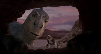 Movie still from “Dinosaur” (2000), directed by Eric Leighton – An image of an animal that is sitting in the dirt; Wide shot, Over the shoulder angle