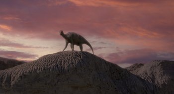 Movie still from “Dinosaur” (2000), directed by Eric Leighton – An animal standing on top of a rock formation; Extreme Wide shot, Low angle