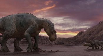 Movie still from “Dinosaur” (2000), directed by Eric Leighton – A dinosaur is standing in the dirt at sunset; Extreme Wide shot, Low angle