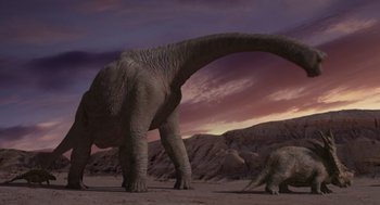 Movie still from “Dinosaur” (2000), directed by Eric Leighton – An adult and a baby elephant walking in the desert; Extreme Wide shot, Low angle