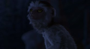 Movie still from “Dinosaur” (2000), directed by Eric Leighton – A white monkey with yellow eyes is standing in the dark; Close Up shot, High angle