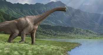 Movie still from “Dinosaur” (2000), directed by Eric Leighton – An image of an animal that is walking in the grass near the water; Extreme Wide shot, Low angle