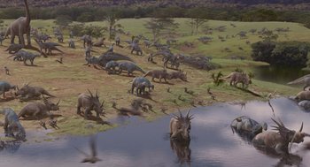 Movie still from “Dinosaur” (2000), directed by Eric Leighton – A herd of horned animals grazing in a grassy field; Extreme Wide shot, High angle