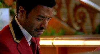 Movie still from “Dirty Pretty Things” (2002), directed by Stephen Frears – A person wearing a suit and tie; Close Up shot, Over the shoulder angle