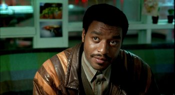 Movie still from “Dirty Pretty Things” (2002), directed by Stephen Frears – A person wearing a leather jacket; Close Up shot, Low angle