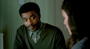 Movie still from “Dirty Pretty Things” (2002), directed by Stephen Frears – A man and a woman sitting in front of each other; Close Up shot, Over the shoulder angle