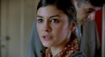 Movie still from “Dirty Pretty Things” (2002), directed by Stephen Frears – A person wearing a floral shirt; Close Up shot, Over the shoulder angle