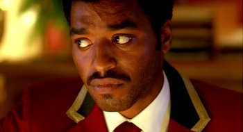 Movie still from “Dirty Pretty Things” (2002), directed by Stephen Frears – A person wearing a suit and tie; Close Up shot, Low angle