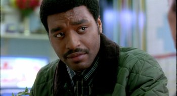 Movie still from “Dirty Pretty Things” (2002), directed by Stephen Frears – A person wearing a green jacket; Close Up shot, High angle