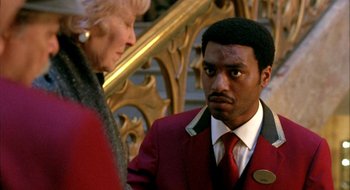 Movie still from “Dirty Pretty Things” (2002), directed by Stephen Frears – A man in a red jacket and a woman in a red suit; Close Up shot, Over the shoulder angle