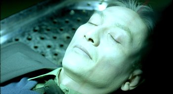 Movie still from “Dirty Pretty Things” (2002), directed by Stephen Frears – A man laying down with his eyes closed; Close Up shot, High angle