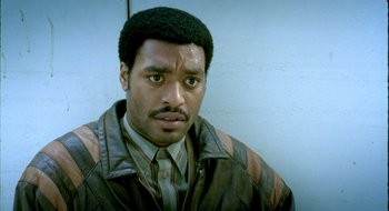 Movie still from “Dirty Pretty Things” (2002), directed by Stephen Frears – A person wearing a jacket; Close Up shot, Low angle