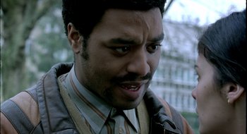 Movie still from “Dirty Pretty Things” (2002), directed by Stephen Frears – A person wearing a suit and tie; Close Up shot, Low angle