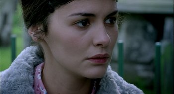 Movie still from “Dirty Pretty Things” (2002), directed by Stephen Frears – A woman's face in a wooded area; Close Up shot, Over the shoulder angle