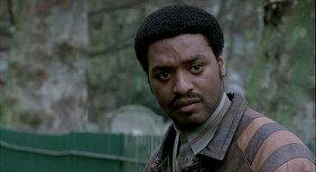 Movie still from “Dirty Pretty Things” (2002), directed by Stephen Frears – A person wearing a jacket; Close Up shot, Low angle