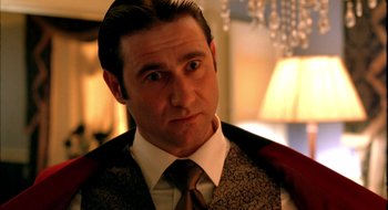 Movie still from “Dirty Pretty Things” (2002), directed by Stephen Frears – A person wearing a suit and tie; Close Up shot, Over the shoulder angle
