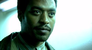 Movie still from “Dirty Pretty Things” (2002), directed by Stephen Frears – A person wearing a suit and tie; Close Up shot, Low angle