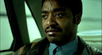 Movie still from “Dirty Pretty Things” (2002), directed by Stephen Frears – A person wearing a suit and tie; Close Up shot, Low angle