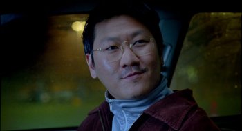 Movie still from “Dirty Pretty Things” (2002), directed by Stephen Frears – A person in a car wearing glasses; Close Up shot, Over the shoulder angle