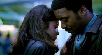 Movie still from “Dirty Pretty Things” (2002), directed by Stephen Frears – A man and a woman looking at one another; Close Up shot, Low angle