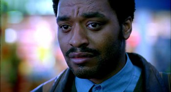 Movie still from “Dirty Pretty Things” (2002), directed by Stephen Frears – A person wearing a suit and tie; Close Up shot, Low angle