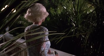 Movie still from “Dirty Rotten Scoundrels” (1988), directed by Frank Oz – An older woman is holding a cell phone in her hand; Medium shot, Low angle