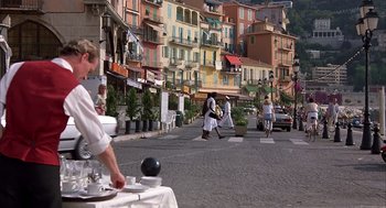 Movie still from “Dirty Rotten Scoundrels” (1988), directed by Frank Oz – People walking down the street on a sunny day; Wide shot, High angle