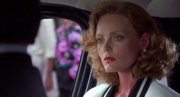 Movie still from “Dirty Rotten Scoundrels” (1988), directed by Frank Oz – A person sitting in a car looking out of the window; Close Up shot, Over the shoulder angle