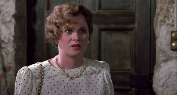 Movie still from “Dirty Rotten Scoundrels” (1988), directed by Frank Oz – A person wearing a necklace; Close Up shot, Over the shoulder angle