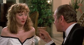 Movie still from “Dirty Rotten Scoundrels” (1988), directed by Frank Oz – A man and a woman sitting at a table talking to each other; Close Up shot, Over the shoulder angle