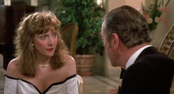Movie still from “Dirty Rotten Scoundrels” (1988), directed by Frank Oz – A man and a woman are sitting at a table talking; Close Up shot, Over the shoulder angle