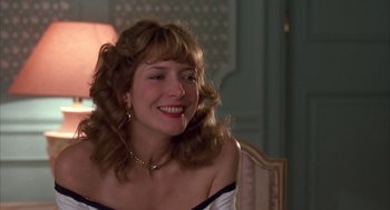 Movie still from “Dirty Rotten Scoundrels” (1988), directed by Frank Oz – A woman with long blonde hair sitting in front of a mirror; Close Up shot, Low angle